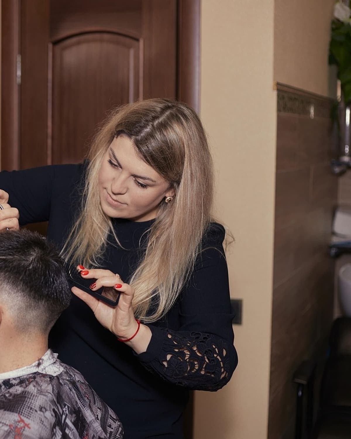 Stylist cutting a client’s hair in a studio